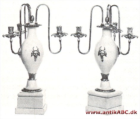 rundt, diamantbesat øresmykke eller lysestage med flere arme kredsformigt stillede 
